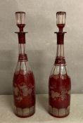A pair of Bohemiqi cranberry flashed and etched decanter