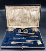 A selection of silver items making up a part vanity set
