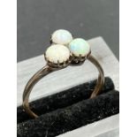 A three stone Opal ring, on untested gold setting. Size S