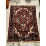 A Persian style rug with repeating pattern (160cm x 110cm)
