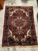 A Persian style rug with repeating pattern (160cm x 110cm)