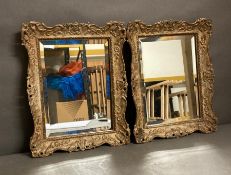 A pair of gilt framed weathered wall mirrors