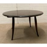 An ercol style Mid Century coffee table on splayed legs (H44cm Dia75cm)