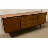 A Mid Century teak sideboard, two cupboard and three drawers (H77cm W184cm D47cm)