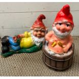 Two garden gnomes, one in a bath tub