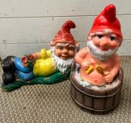 Two garden gnomes, one in a bath tub