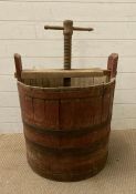 A vintage metal banded barrel apple press