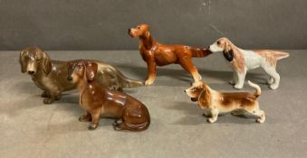 A selection of ceramic dogs to include Dachshunds, Bassett Hound and a Pointer
