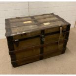 A vintage wooden and metal banded steamer trunk