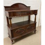 A mahogany serving buffet, a galleried top on four supports ending in a two door cabinet (H129cm