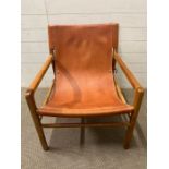 A leather sling chair with teak frame