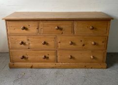A pine three over four chest of drawers (H80cm W149cm D49cm)