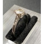 A diamond ring set in platinum with diamond shoulders (5mm diameter stone) (Size M)