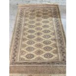 A cream ground wool rug with central medallion (130cm x 206cm)