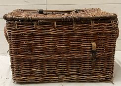 A reclaimed wicker laundry basket with lid and handles to sides