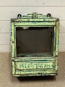 A distressed wall hanging cabinet