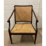 A mahogany cane seated arm chair