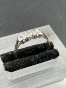 An 18ct gold and platinum setting three stone diamond ring. (Approximate Total Weight 2g) Size P