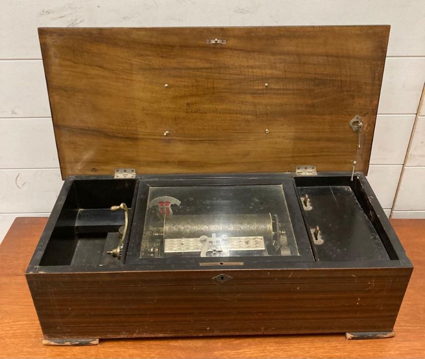 A late 19th Century cylinder music box with an inlaid lid