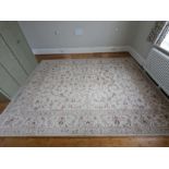 A large floral pattern rug with cream grounds and light pink flowers (350cm x 270cm)