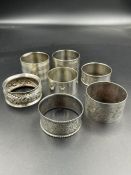 A selection of seven silver napkin rings, various makers, styles and hallmarks. (Approximate Total