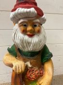 A garden gnome holding a shovel and flowers (H70cm)