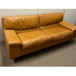 A Mid Century leather two seater sofa with a matching lounge chair and foot stool (Sofa H77cm W200cm