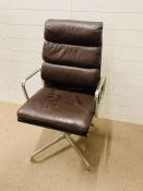 A softpad EA 219 desk chair in brown leather and brushed aluminum by Eames