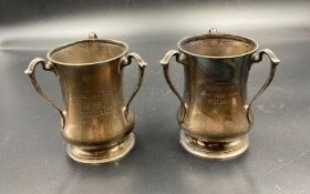 Two hallmarked silver presentation three handled cups 1930's (Approximate Total Weight 370g)