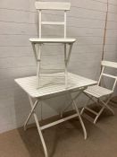 A metal and wooden white painted folding bistro set