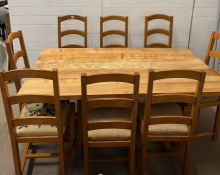 A light oak dining table with eight chairs