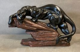 An Austin sculpture of a black panther prowling, signed
