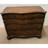 A George III style mahogany serpentine dressing chest with four long graduating drawers and the