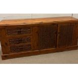 A carved sideboard with drawers one end and cupboard to other (H82cm W189cm D48cm)