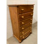 A Cotswold collection, pine chest of drawers on bun feet (H114cm W68cm D42cm)