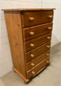 A Cotswold collection, pine chest of drawers on bun feet (H114cm W68cm D42cm)