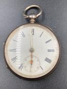A silver pocket watch, hallmarked for London 1877.