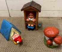Two garden gnomes, one in the loo and one in a tent