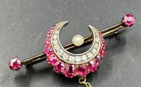 A diamond and garnet crescent brooch