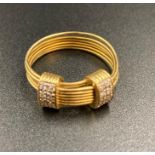 An 18ct gold Links ring with two pave diamond set extenders. (Approximate Total Weight 5.5g)