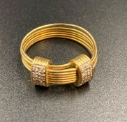 An 18ct gold Links ring with two pave diamond set extenders. (Approximate Total Weight 5.5g)