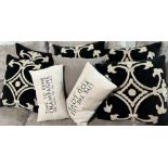 Six black and cream cushions with two small cushions