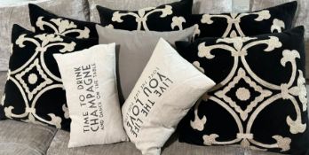 Six black and cream cushions with two small cushions