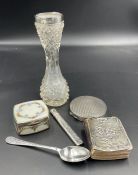 A selection of silver curios to include a compact, enamel pill box, teaspoon, silver covered book of