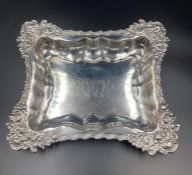 An ornate silver serving dish, engraved to centre, beehive mark and approximate total weight 530g