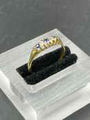 A sapphire and diamond ring with alternating stones on an untested gold setting. Size R