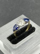 A Diamond and sapphire ring on an 18ct yellow gold setting (Central stone 6mm x 5mm) Size L