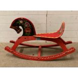 A Russian hand painted wooden rocking horse with floral decoration