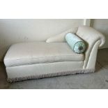 An upholstered day bed with bolster cushions (H84cm W183cm D85cm)