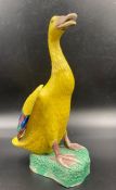 An early 20th Century Chinese glazed yellow ceramic duck marked to base